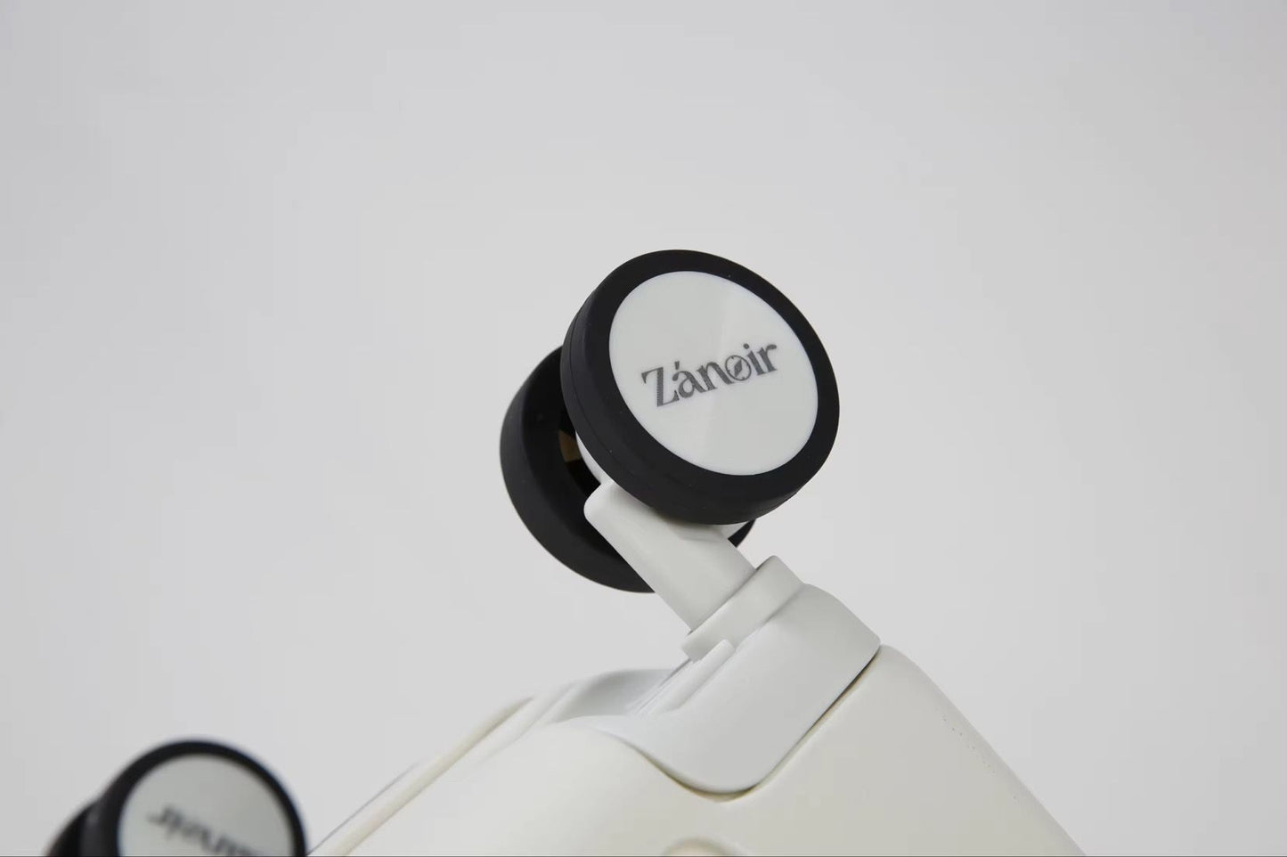 Close-up of polar white carry-on suitcase wheel with brand logo