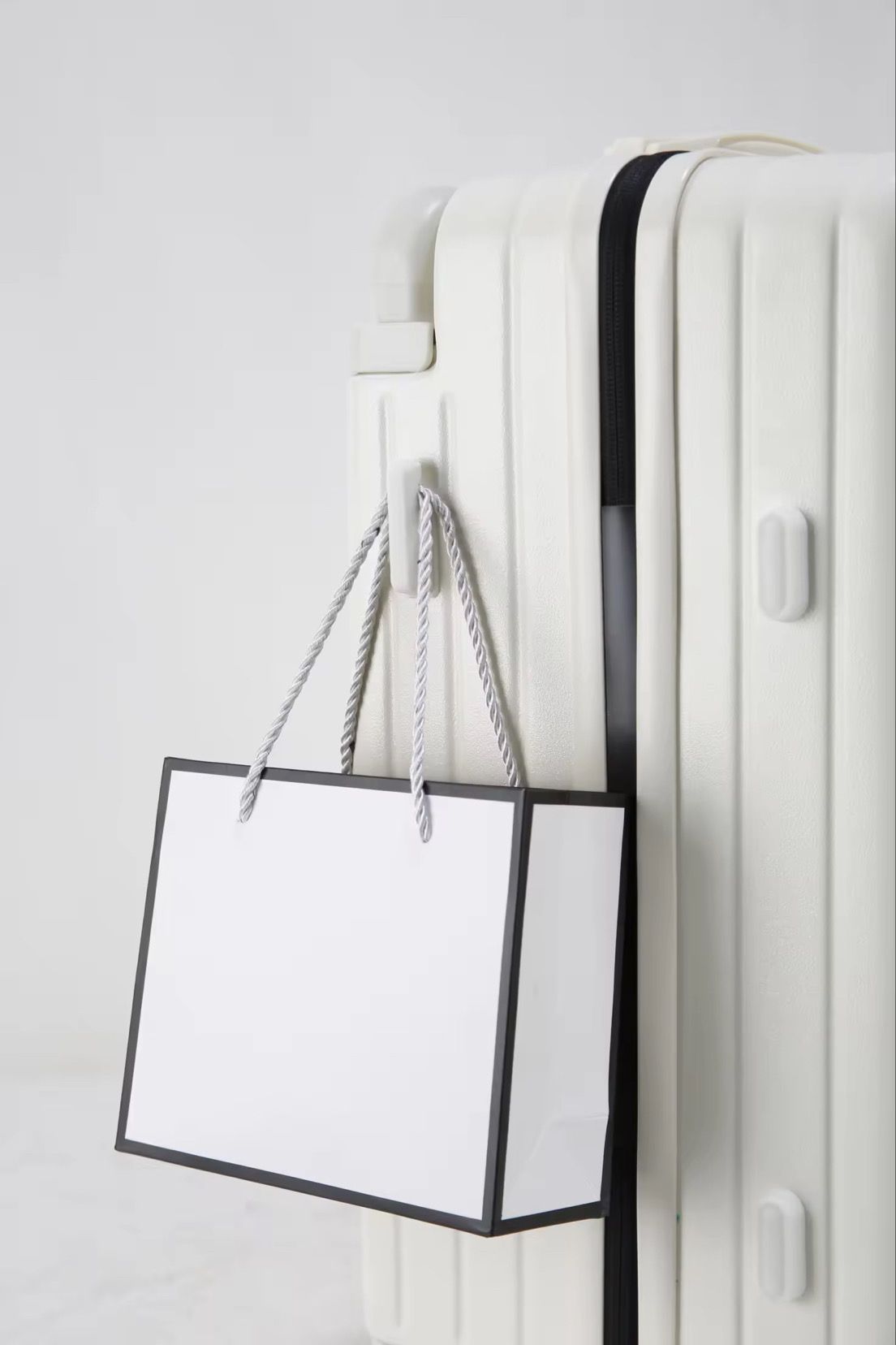 White travel suitcase with side hook